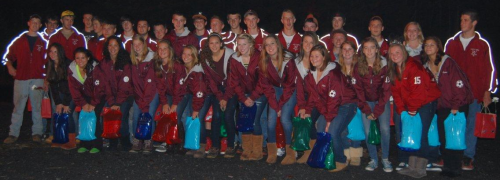 The Varsity Boys and Girls Teams gather for a North Street bonfire on the Friday of Columbus Tournament weekend.