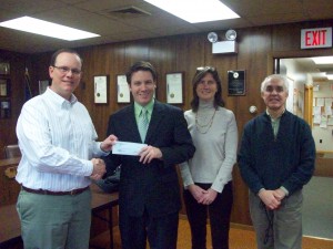 At left, Town of Webb Supervisor Ted Riehle receives a gant check from Adam Hutchinson, Director, Herkimer County HealthNet. To the right of Hutchinson are Page Hannah, West Adirondack Recreation Development Association, and Nick Rose, Executive Director of CAP-21. Courtesy photo. 
