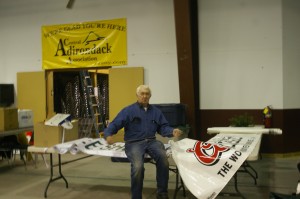 Bob Gordon unfurls banners for hanging at Snodeo. Photos by Dana Armington