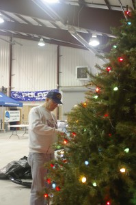 Bob Gates decorates the Christmas tree.