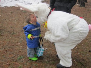 Mason Cahill, 21 months old, greets the Easter Bunny. Photo by Wende Carr