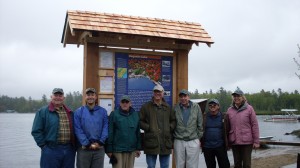Lined up in front of the Raquette Lake kiosk are, from left, Jim Kammer, Walter Oposzynski, Alan Bennett, Jeffery Sellon, John Sammon, and Kevin & Sue Norris