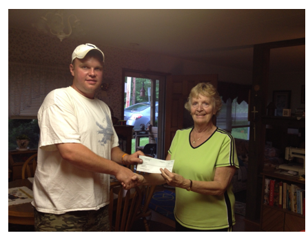 Chief Jeff Abrial presents a check for $176 to Program Director Sonya Skidmore