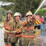 Old Forge Fire Chief Charlie Bogardus directs the hose in last Friday's Pushball competition, with support from department members Billy Tormey and Ronnie Parent