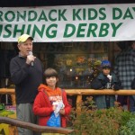 Paul Chambers of French Louie's store in Inlet announces a fishing derby winner at last years Adirondack Kids Day