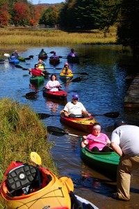 Some of the paddle for the Cure participants navigate the Moose River
