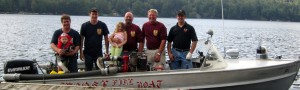 Big Moose Fire Co. Fire Boat with, from left, Ken Hinckley owner of Dunn’s Boat Service; Fire Chief Jason Pratt; TOW Fire Commis­sioner Jeff Ossont; TOW Fire Commissioner Pete Croneiser and Asst. Chief Craig Smith. Also shown are two future volunteers. Courtesy photo