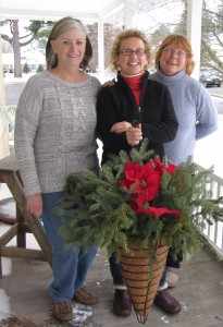 Shellie Organski, Kate Russell and Kristin Frymire display a finishing Main Street basket. Photo by Gina Greco