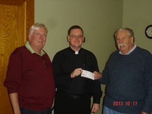 Deputy Grand Knight James Foley, Father Shane Lynch, pastor of the Catholic Churches of the Fulton Chain, and Bob Stanton, Grand Knight of the Old Forge Knights of Columbus. 