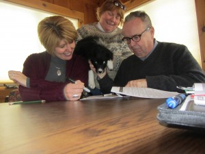 CAP-21’s Sandy Booton, Kristin Frymire and Tim Foley review  documents with Dixie. Photo by Gina Greco