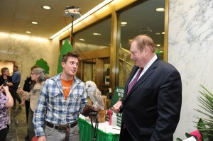 Assemblyman Marc W. Butler speaks with Conner John Schmidt, an intern from the Adirondack Wildlife Rehabilitation and Refuge Center, who is handling a North American Barn Owl, one of the many species found in the region. Courtesy photo