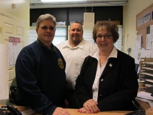 Motor Vehicle Clerk John Abdo, center, at the Old Forge DMV Office, with Herkimer County Legislator Patrick Russell, and Herkimer County Clerk Sylvia Rowan. Photo by Gina Greco