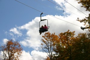 Riders on a chair of the  McCauley Mountain lift.  Photo by Gina Greco