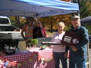 Old Forge Farmers’ Market co-managers Barbara and Reed Proper, right, with vendors Paul and Patti Bunnelle, owners of Fair Haven Farm in Middleville. Photo by Marianne Christy