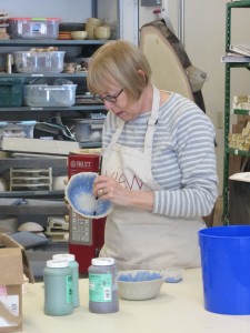 Deb Munyan of Okara Lake glazes a pottery creation for Saturday’s Chili Bowl Luncheon at VIEW in Old Forge. Photo by Gina Greco