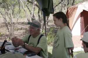Dr. Gordon Howard with a bird and  young birder Sophie watching