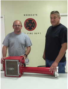 Woodgate Fire Chief Tony Sege, left, and Assistant Chief Scott Cornell  display their department’s new piece of equipment. Courtesy photo