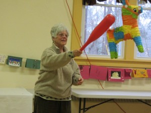 SHARP participant Penny Smedley takes a whack at the piñata during Mexican Fiesta Day, Wednesday, December 2. Photo by Gina Greco
