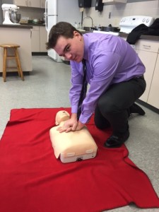 Webb student T. Hulser demonstrates  CPR on a practice figure. Courtesy photo